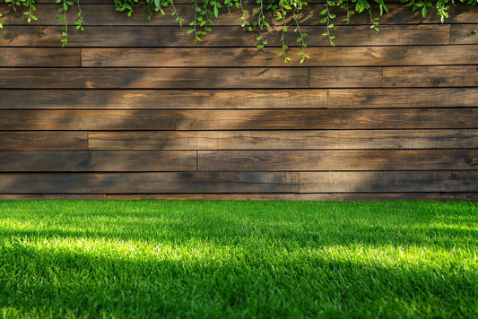 Green grass lawn and wooden wall.